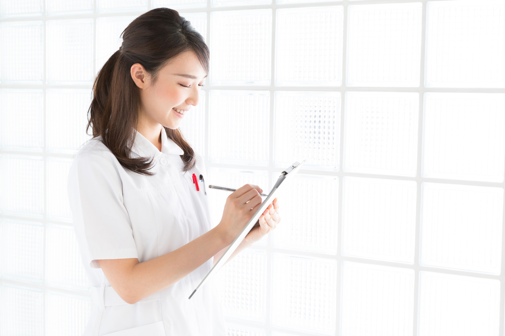 Japanese female nurse holding a clip board
